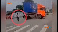 В Китае велосипедист решил пересечь шоссе и чуть не попал под колеса многотонника